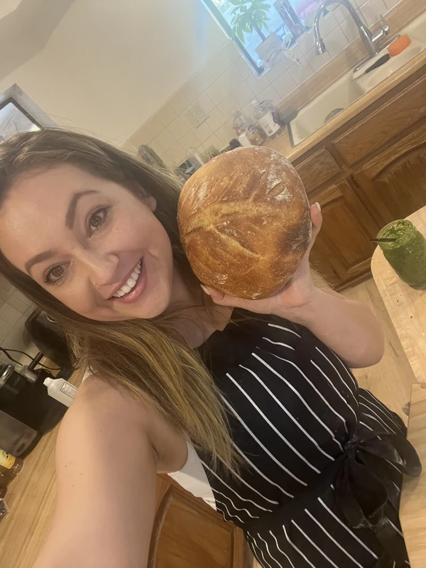 Elena with a fresh loaf of bread